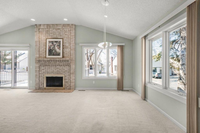 8425 Rice Lake Rd, Maple Grove, MN 55369 - unfurnished living room with a textured ceiling, lofted ceiling, light carpet, and a fireplace