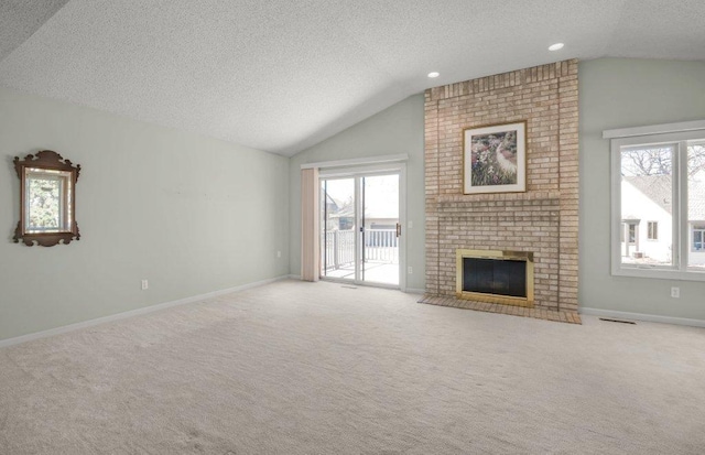 8425 Rice Lake Rd, Maple Grove, MN 55369 - unfurnished living room with vaulted ceiling, a textured ceiling, light colored carpet, a fireplace, and recessed lighting