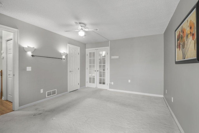 8425 Rice Lake Rd, Maple Grove, MN 55369 - empty room featuring a ceiling fan, french doors, carpet floors, and a textured ceiling