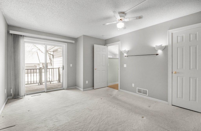 8425 Rice Lake Rd, Maple Grove, MN 55369 - unfurnished bedroom with access to outside, carpet floors, a textured ceiling, and ceiling fan