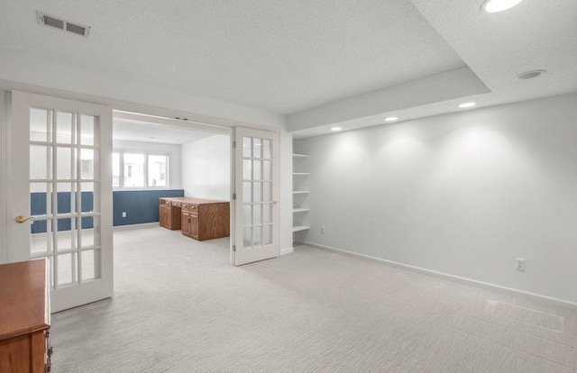 8425 Rice Lake Rd, Maple Grove, MN 55369 - unfurnished room with french doors, recessed lighting, light colored carpet, and a textured ceiling