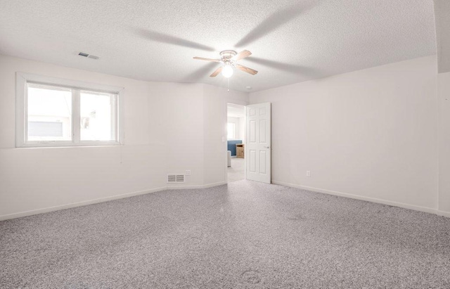8425 Rice Lake Rd, Maple Grove, MN 55369 - spare room featuring a textured ceiling, ceiling fan, and carpet