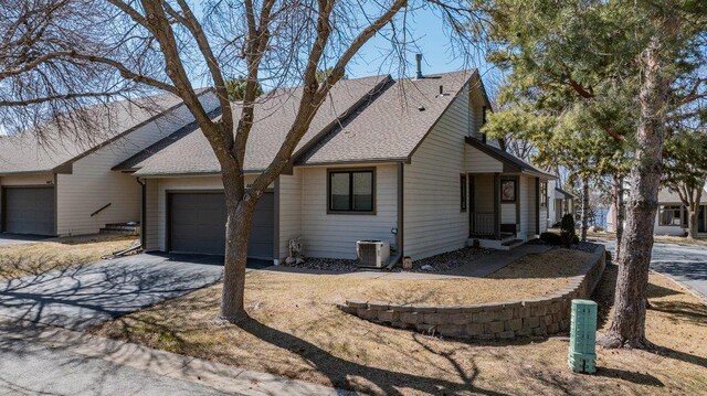 8425 Rice Lake Rd, Maple Grove, MN 55369 - view of front of house with driveway, an attached garage, and a shingled roof