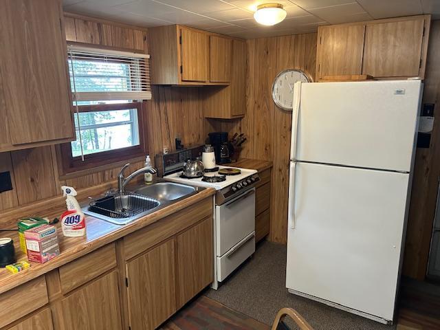 1906 Hay Lake Dr NW, Ponto Lake Twp, MN 56474 - kitchen with white appliances, light countertops, and wooden walls