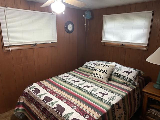 1906 Hay Lake Dr NW, Ponto Lake Twp, MN 56474 - bedroom with wooden walls and ceiling fan