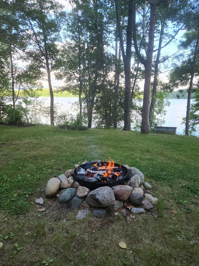 1906 Hay Lake Dr NW, Ponto Lake Twp, MN 56474 - view of green lawn featuring an outdoor fire pit and a water view