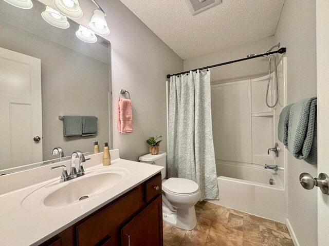 8389 Norwood Ln N, Maple Grove, MN 55369 - full bathroom with vanity, shower / bath combination with curtain, a textured ceiling, and stone finish flooring
