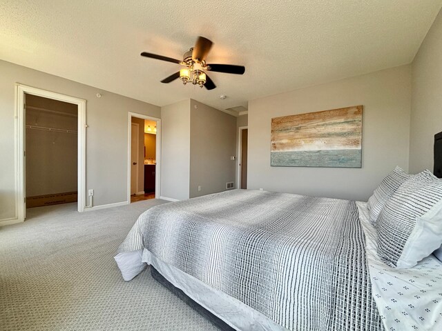 8389 Norwood Ln N, Maple Grove, MN 55369 - carpeted bedroom with ceiling fan, a textured ceiling, a closet, a walk in closet, and ensuite bath
