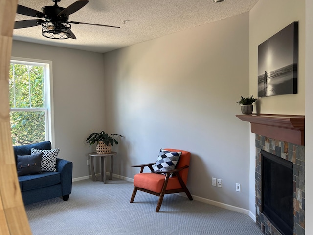 8389 Norwood Ln N, Maple Grove, MN 55369 - living area with a fireplace, carpet flooring, a textured ceiling, and ceiling fan