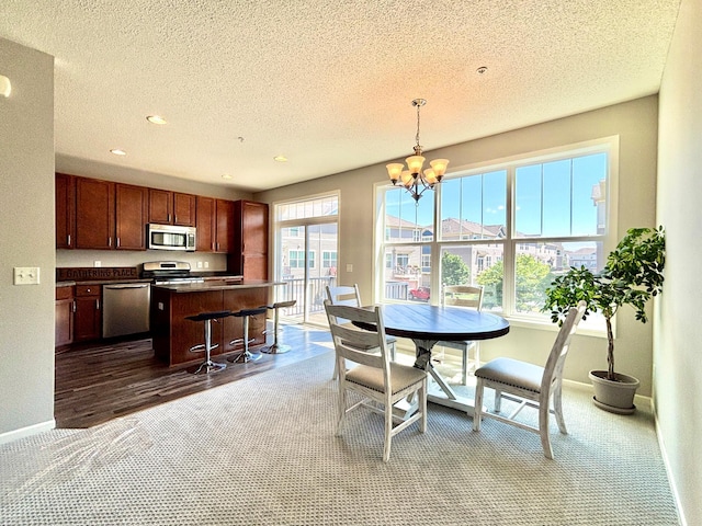 8389 Norwood Ln N, Maple Grove, MN 55369 - carpeted dining space featuring a textured ceiling, a chandelier, and recessed lighting