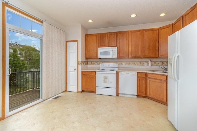 7710 Elm Grove Ct, New Hope, MN 55428 - kitchen featuring white appliances, light countertops, light flooring, brown cabinetry, and recessed lighting