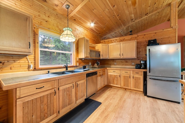 4767 Mccomber Rd, Duluth, MN 55803 - kitchen with stainless steel appliances, light brown cabinetry, light wood-type flooring, wooden walls, and hanging light fixtures