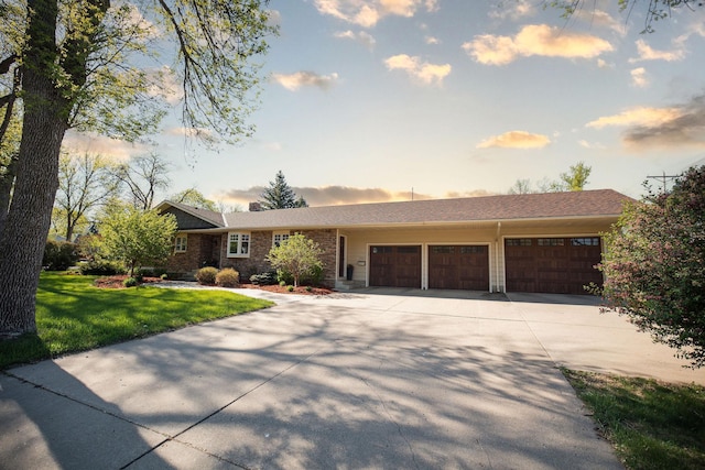 701 Oak Ave, Olivia, MN 56277 - ranch-style home with a garage, driveway, a yard, and brick siding