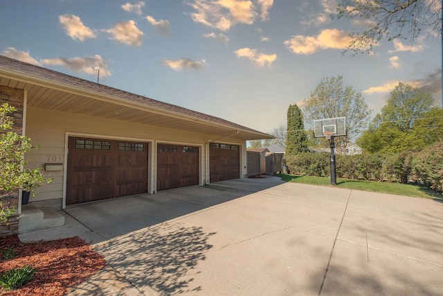 701 Oak Ave, Olivia, MN 56277 - garage featuring concrete driveway and a shed