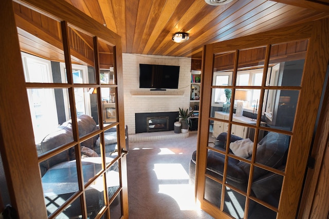 701 Oak Ave, Olivia, MN 56277 - carpeted living room featuring wood ceiling, healthy amount of natural light, french doors, and a brick fireplace