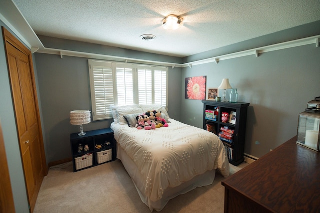 701 Oak Ave, Olivia, MN 56277 - bedroom featuring light colored carpet and a textured ceiling