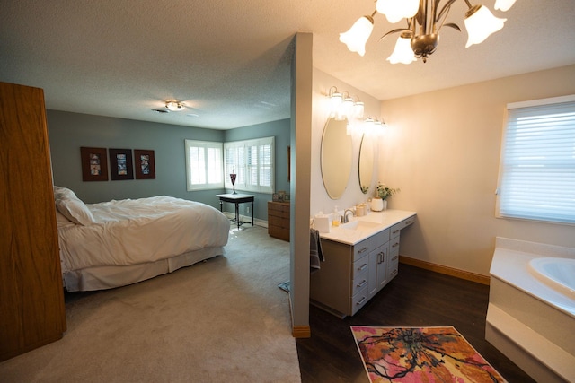 701 Oak Ave, Olivia, MN 56277 - bedroom featuring a chandelier, a textured ceiling, and dark wood-style flooring