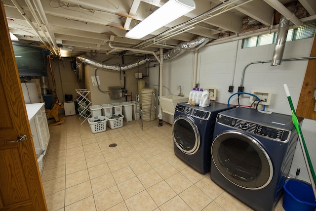 701 Oak Ave, Olivia, MN 56277 - washroom with washing machine and dryer and light tile patterned floors