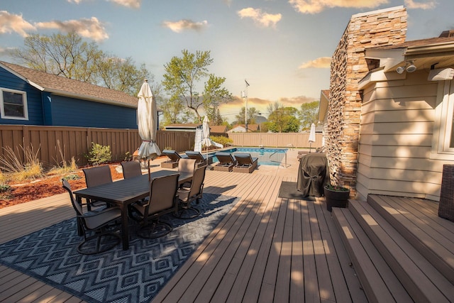 701 Oak Ave, Olivia, MN 56277 - deck with outdoor dining space, a storage shed, and a fenced backyard