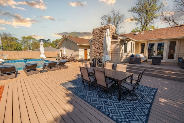 701 Oak Ave, Olivia, MN 56277 - deck at dusk with outdoor dining space, an outdoor living space, and french doors