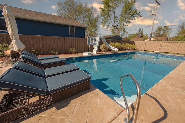 701 Oak Ave, Olivia, MN 56277 - view of swimming pool with a water slide, a fenced backyard, a patio area, and a diving board
