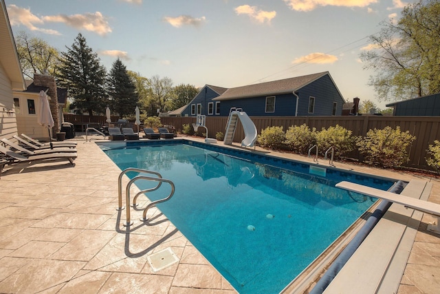 701 Oak Ave, Olivia, MN 56277 - view of swimming pool with a water slide, a patio, and a diving board
