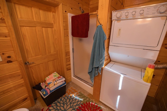701 Oak Ave, Olivia, MN 56277 - laundry area with estacked washer and dryer and wooden walls