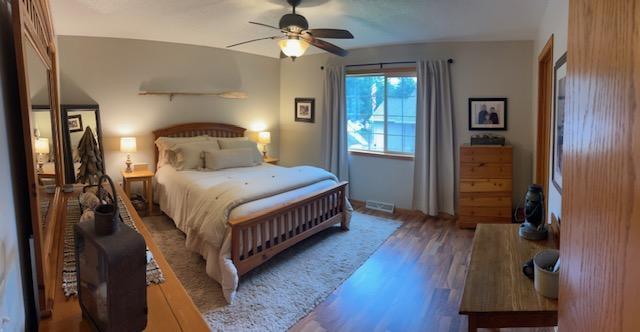 302 Peifer Dr, Litchfield, MN 55355 - bedroom with wood finished floors and a ceiling fan