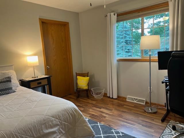 302 Peifer Dr, Litchfield, MN 55355 - bedroom with wood finished floors and baseboards