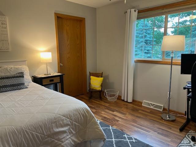 302 Peifer Dr, Litchfield, MN 55355 - bedroom featuring wood finished floors and baseboards