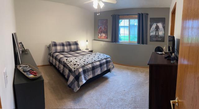 302 Peifer Dr, Litchfield, MN 55355 - bedroom featuring light carpet and ceiling fan