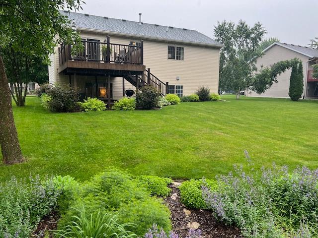 302 Peifer Dr, Litchfield, MN 55355 - back of house with a deck, stairs, and a yard