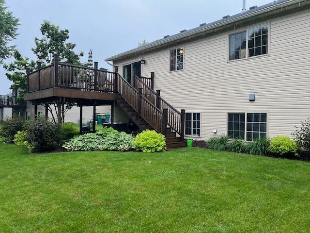 302 Peifer Dr, Litchfield, MN 55355 - back of property with a lawn, a deck, and stairs