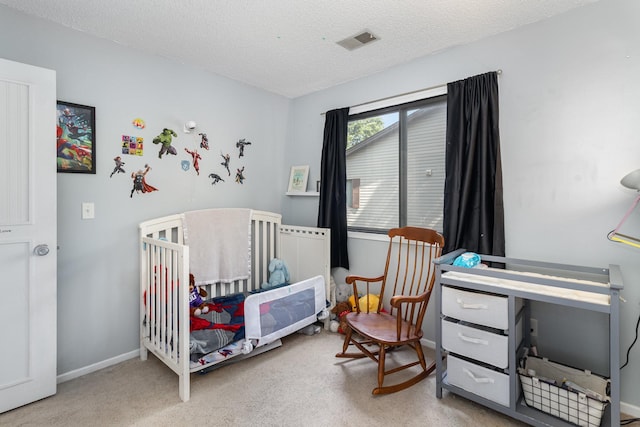 6668 84th Ct N, Brooklyn Park, MN 55445 - bedroom with a textured ceiling, a nursery area, and carpet floors