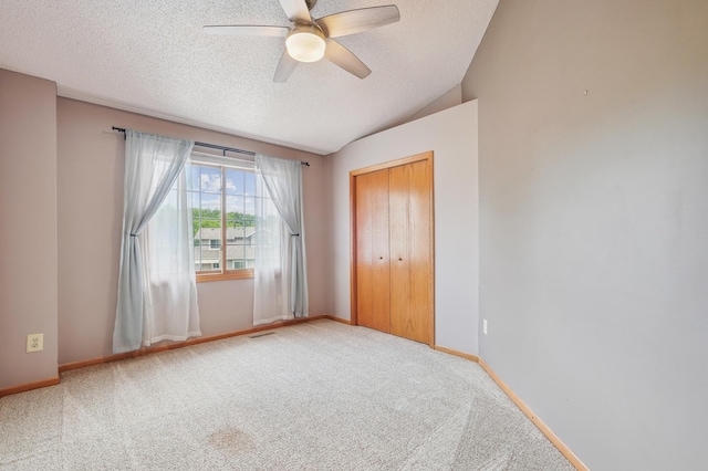 6936 Lake Ter E, Woodbury, MN 55125 - carpeted spare room featuring a ceiling fan, a textured ceiling, and lofted ceiling