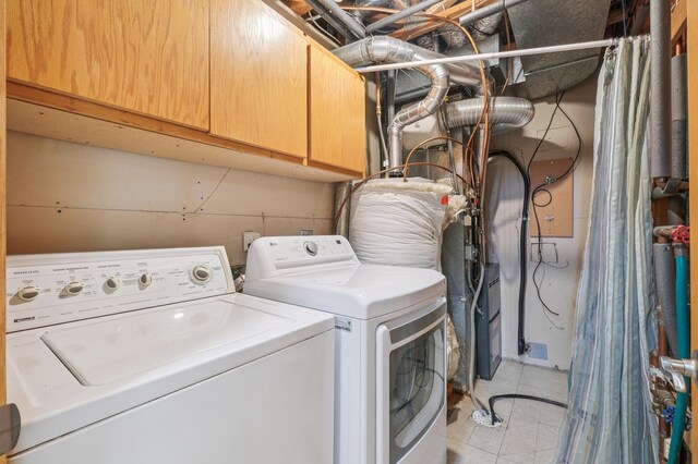 6936 Lake Ter E, Woodbury, MN 55125 - laundry area featuring washing machine and dryer, cabinet space, and light tile patterned flooring