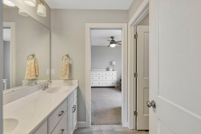 18175 61st Ave N, Plymouth, MN 55446 - ensuite bathroom featuring double vanity, a ceiling fan, and wood finished floors