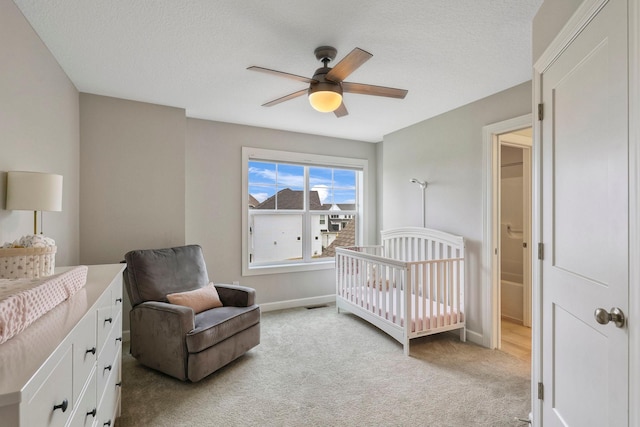 18175 61st Ave N, Plymouth, MN 55446 - bedroom with light colored carpet, a nursery area, ceiling fan, and a textured ceiling