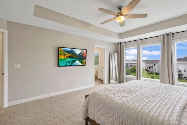 18175 61st Ave N, Plymouth, MN 55446 - bedroom featuring light colored carpet, multiple windows, ensuite bath, and a ceiling fan