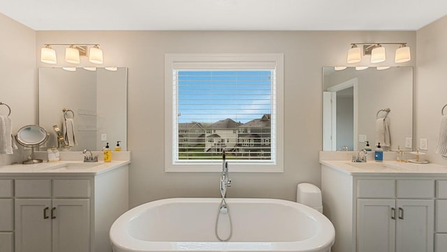 18175 61st Ave N, Plymouth, MN 55446 - bathroom featuring plenty of natural light, two vanities, and a freestanding tub