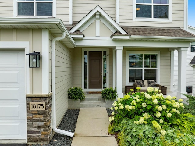 18175 61st Ave N, Plymouth, MN 55446 - view of exterior entry featuring a garage, a shingled roof, and a porch