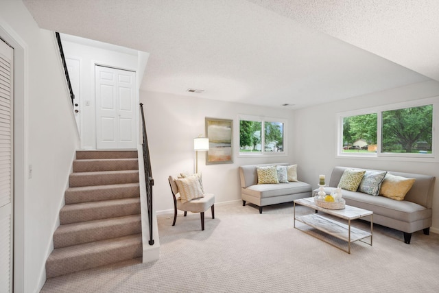 12908 Belle Aire Dr, Champlin, MN 55316 - carpeted living area featuring stairs and a textured ceiling