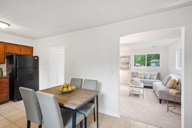 12908 Belle Aire Dr, Champlin, MN 55316 - dining space featuring light tile patterned flooring, light carpet, and a textured ceiling