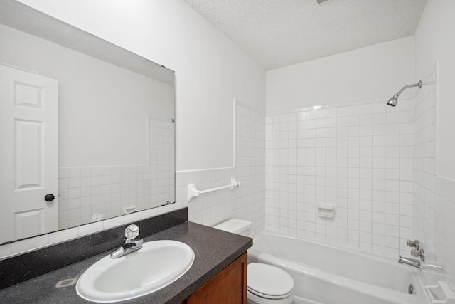 12908 Belle Aire Dr, Champlin, MN 55316 - full bath featuring vanity, bathtub / shower combination, a textured ceiling, tile walls, and wainscoting