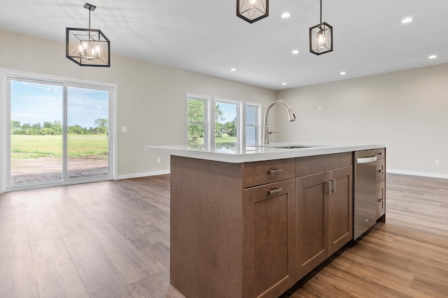 1720 Summer Ln NE, Alexandria, MN 56308 - kitchen featuring dishwasher, light countertops, light wood-style floors, recessed lighting, and decorative light fixtures