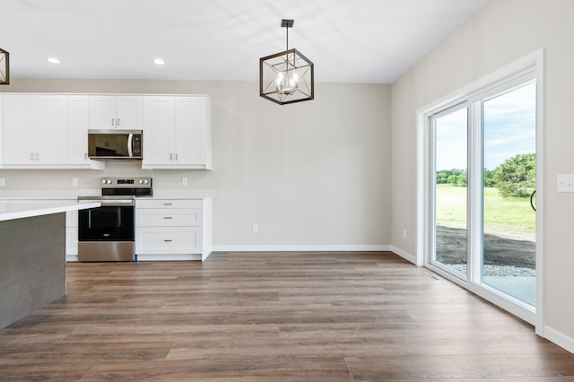 1720 Summer Ln NE, Alexandria, MN 56308 - kitchen with stainless steel appliances, healthy amount of natural light, a chandelier, light countertops, and recessed lighting
