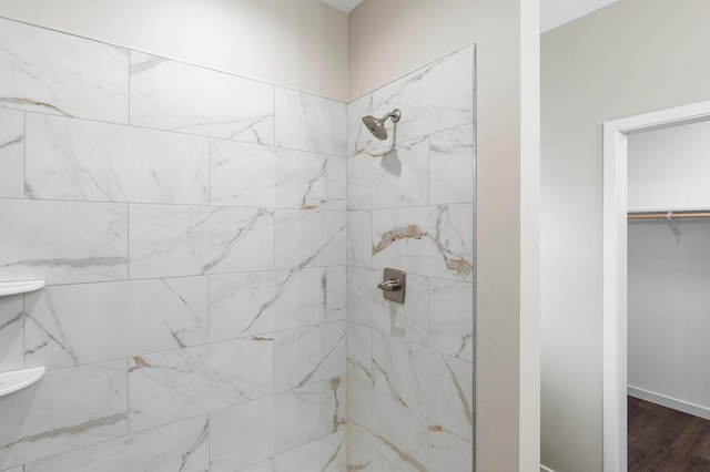 1720 Summer Ln NE, Alexandria, MN 56308 - full bathroom with tiled shower, wood finished floors, and a walk in closet