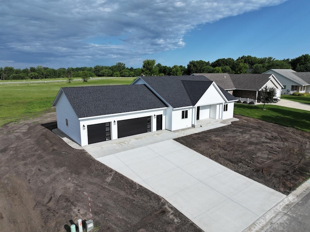1720 Summer Ln NE, Alexandria, MN 56308 - view of front facade featuring an attached garage, driveway, a front lawn, a shingled roof, and view of scattered trees
