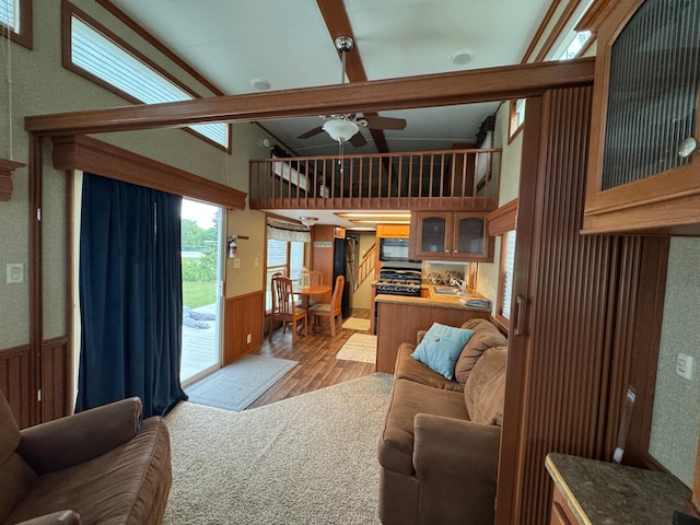 1540 US Highway 59 Unit 203, Detroit Lakes, MN 56501 - living area with wood finished floors, a wainscoted wall, and ceiling fan