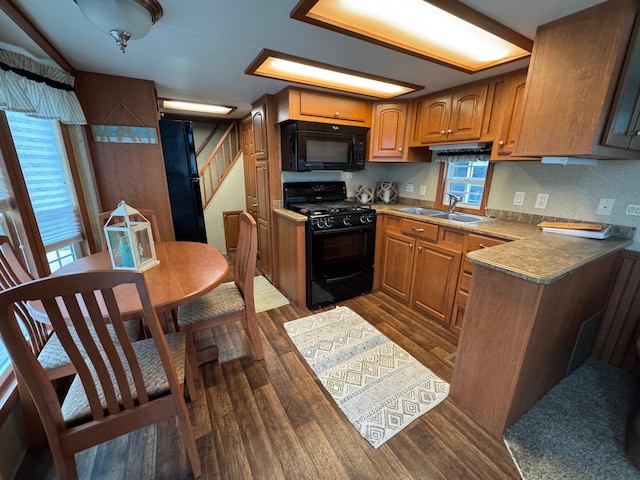 1540 US Highway 59 Unit 203, Detroit Lakes, MN 56501 - kitchen featuring black appliances, dark wood-style flooring, and brown cabinets